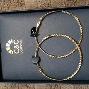 Silver hoop earrings they have small shiny beads on them